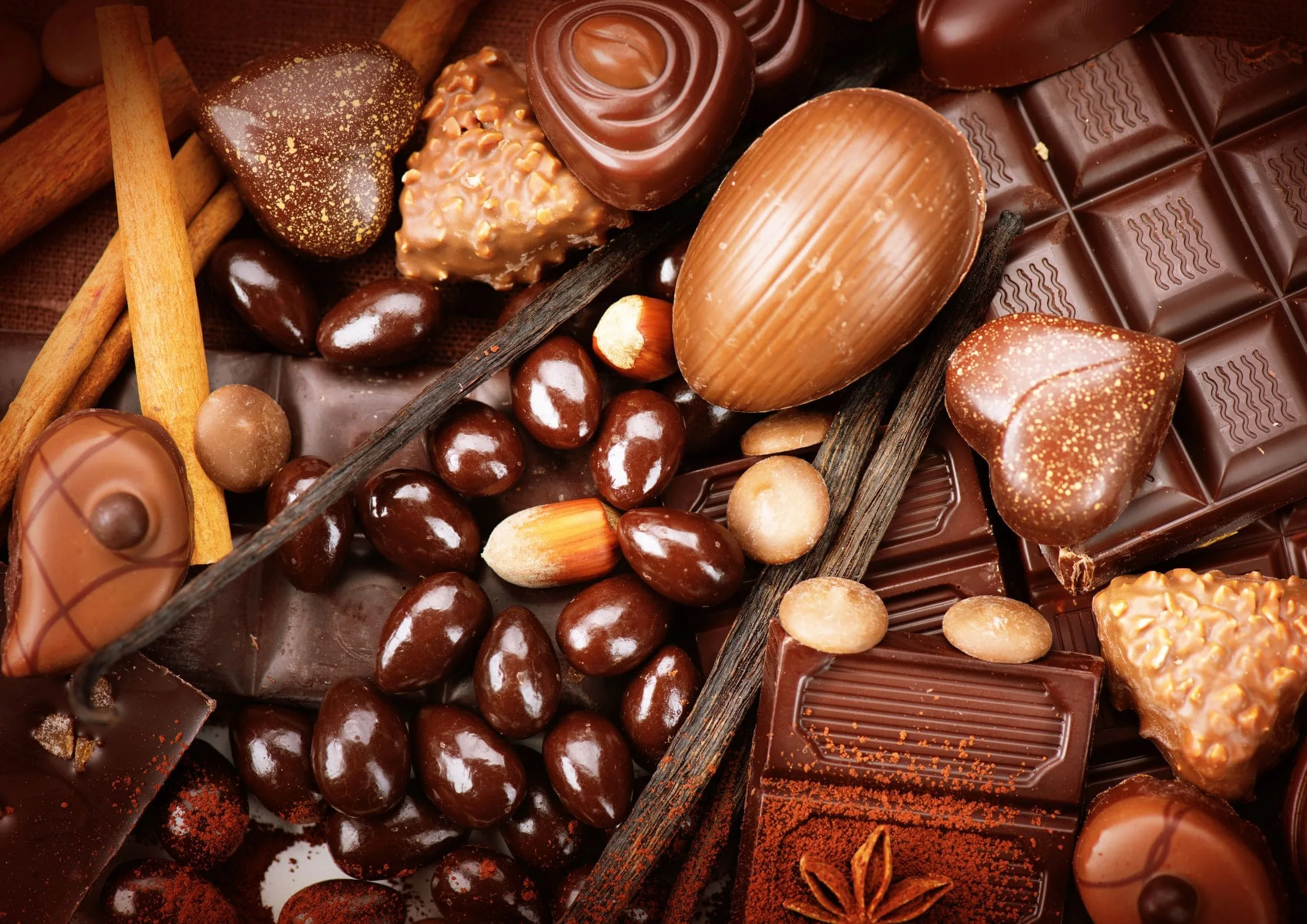 A pile of chocolates and nutsDescription automatically generated